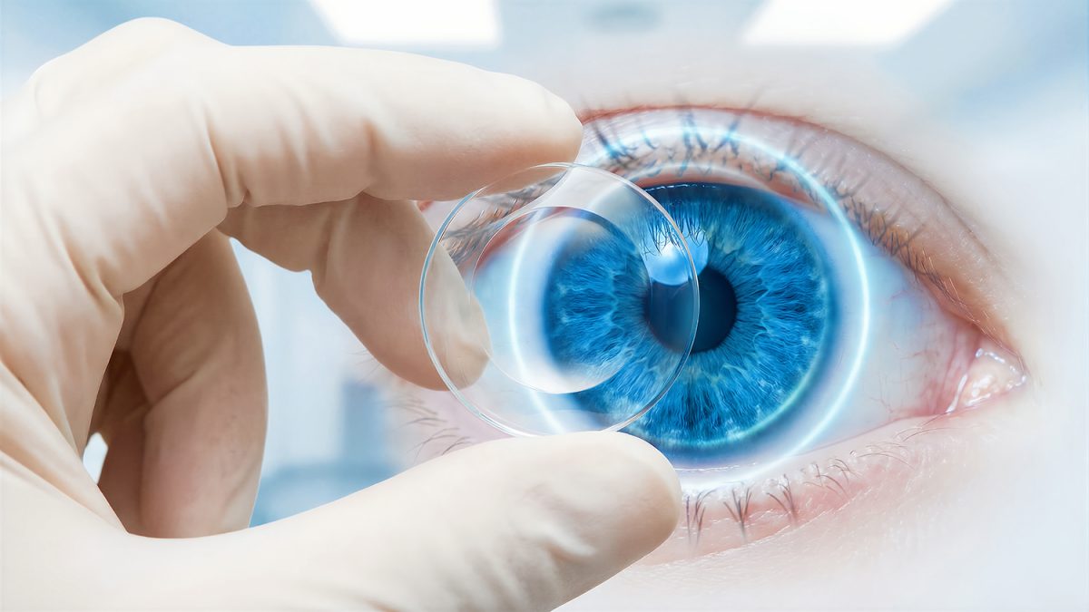 Close up of an optometrist applying a clear corrective contact l New Lens Technology Contacts